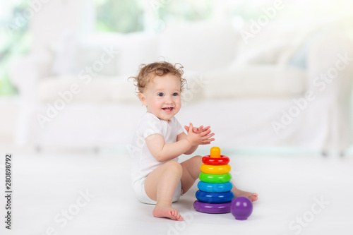 Baby playing with toys. Toy for child. Kids play.