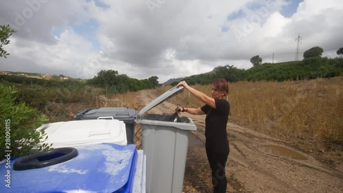 girl collects waste by throwing a bag into the appropriate waste bin seen in stop motion photo