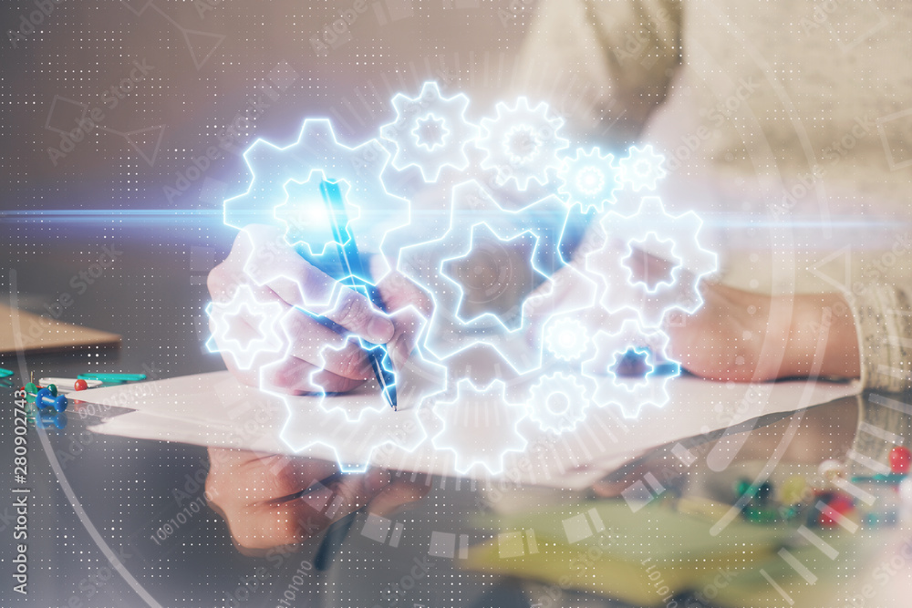 International business hologram over woman's hands taking notes background. Concept of success. Double exposure International business hologram over woman's hands taking notes background. Concept of success. Double exposure