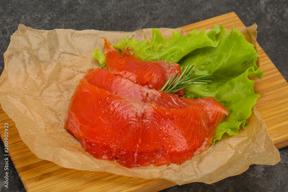 Sliced salmon fillet served rosemary