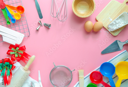 Baking utensils and ingredients is frame on pink pastel background. Text space images, top view.