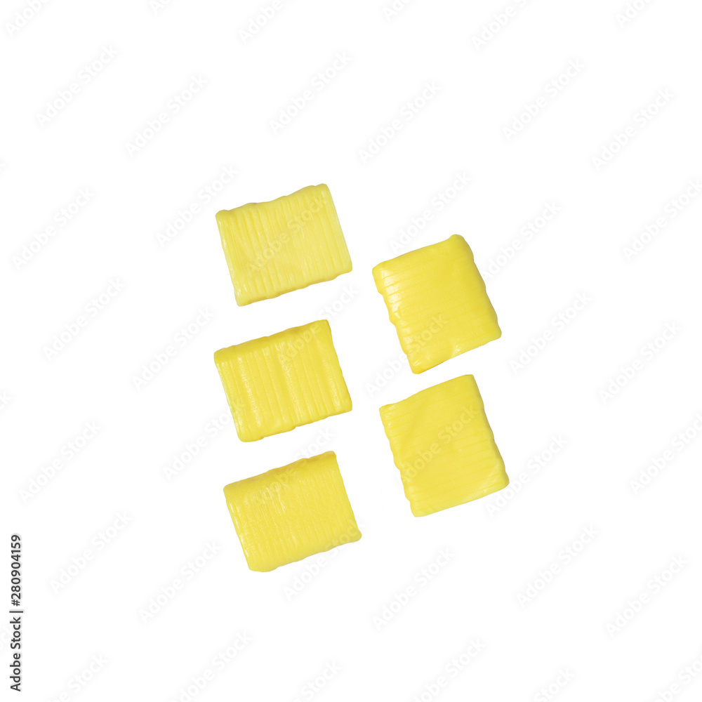 five yellow rectangular chewy candy isolated on a white background