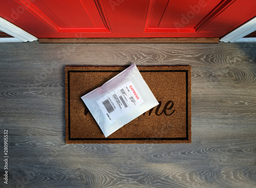 Express envelope package delivered outside door. Overhead view.