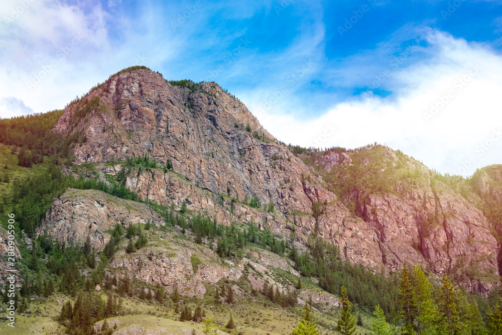 part of the Altai rocky mountains against the blue sky. Beautiful nature of Siberia in Russia part of the Altai rocky mountains against the blue sky. Beautiful nature of Siberia in Russia