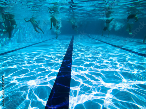 People diving in a swiming pool. Underwater view. © nvphoto