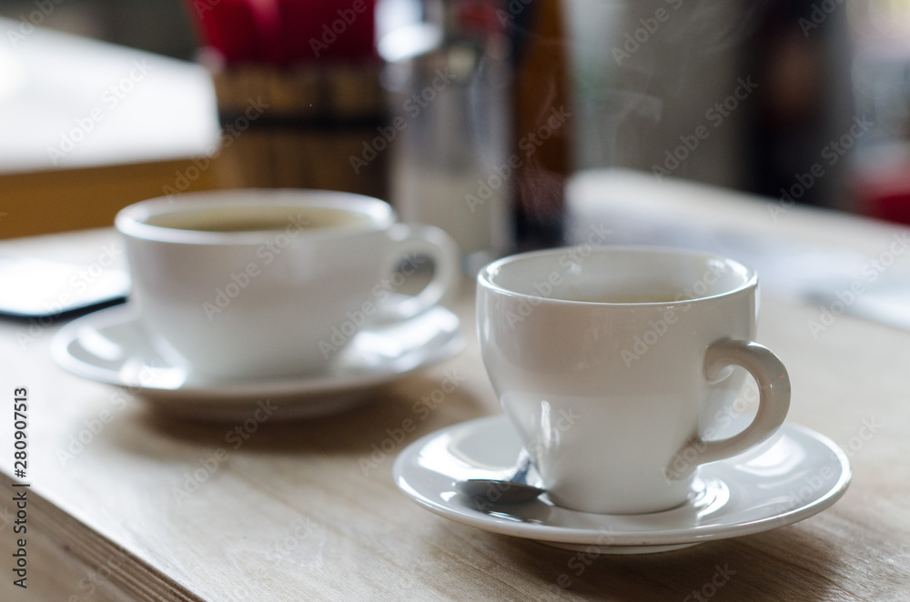 two coffee cups in a coffee shop two coffee cups in a coffee shop