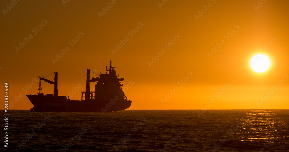 Cape Town, South Africa ship silhouette at sunset.