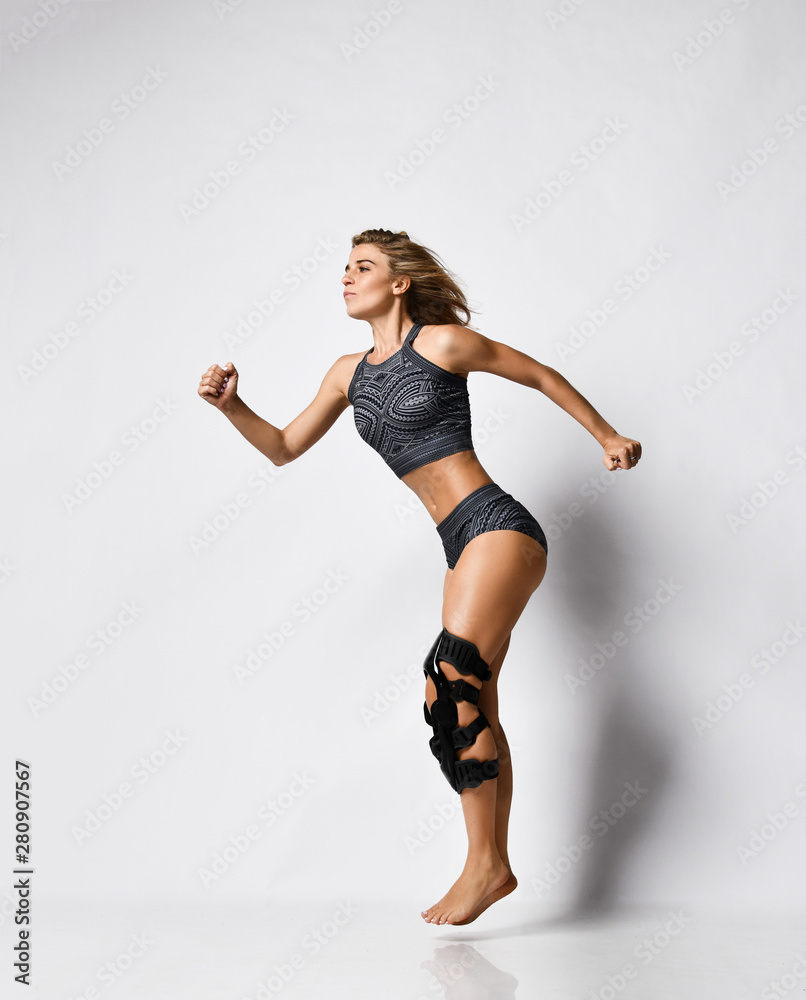 Woman with knee brace. Isolated.