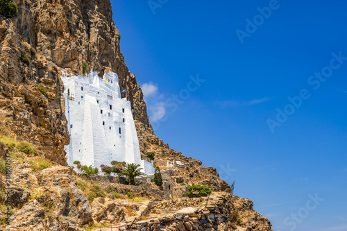 Amorgos whitewashed monastery on the cliff side, Greece.