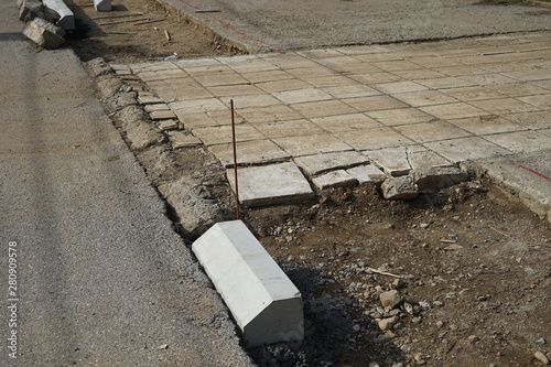 Reconstruction of the sidewalk and replacement of old curbs. Construction zone