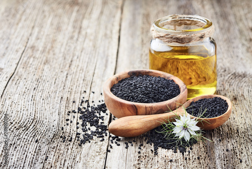 Black cumin oil with seeds and flower nigella sativa photo