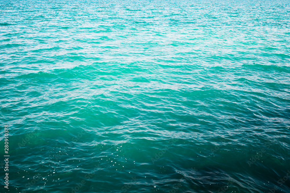 Obraz premium Shining blue water ripple background. Tropical backdrop.