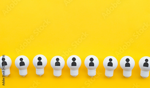 Teamwork concepts with human icon on group of lightbulb on pastel color background.Business solution