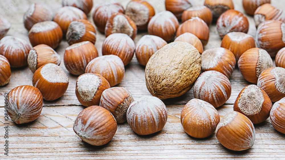 Hazelnut heap on wooden table, selective focus Hazelnut heap on wooden table, selective focus