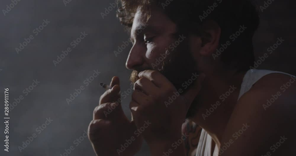 Depressed drug addict smoking