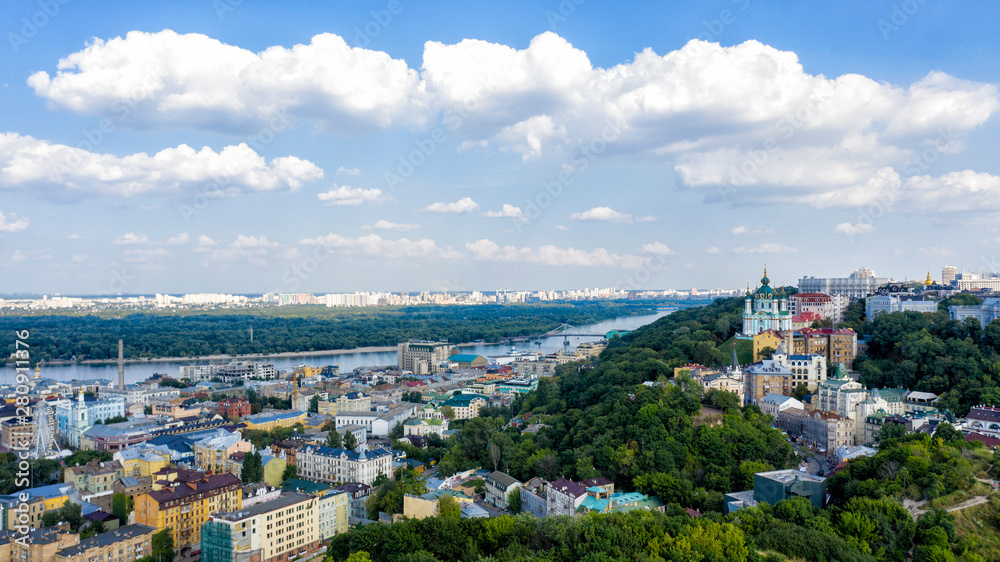 Aerial top view of Saint Andrew's church and Andreevska street from above, cityscape of Podol district on sunset, skyline of city of Kiev (Kyiv), Ukraine