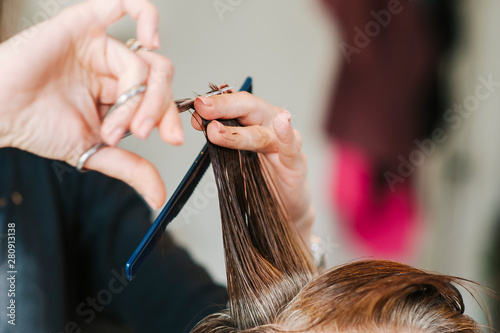 The hairdresser is cutting out hair