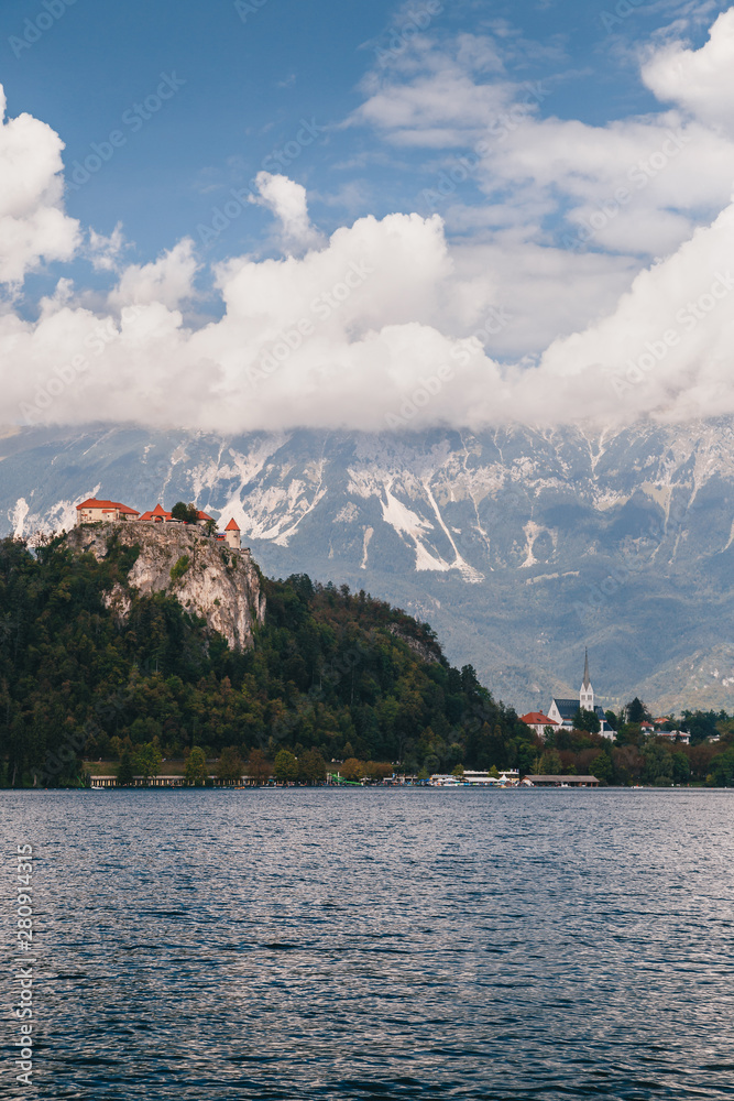 Close up view of the Bled Castle, the Bled city, St. Martin's Parish Church, parks and beaches situated on the bank of the Lake Bled, surrounded by forest and mountains. Travel concept.