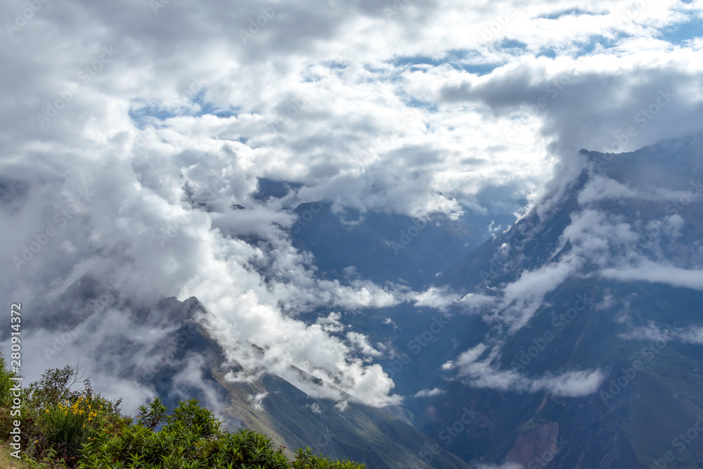 Blurred background with the cloud-covered mountain peaks of Apurimac river valley, Peru
