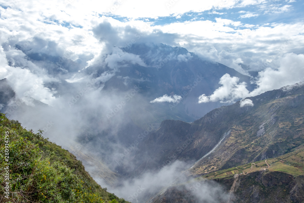 Blurred background with the cloud-covered mountain peaks of Apurimac river valley, Peru