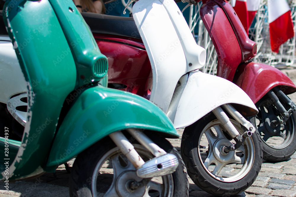 Red, green and white scooters symbolize the prapor of Italy, close-up of transport