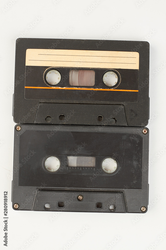 Obraz premium Two black audio tapes. Old cassette tapes isolated on white background. Music retro storage technology.