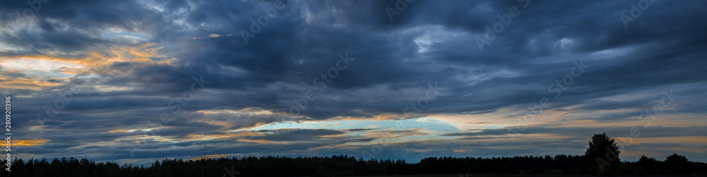 Panorama of the sky with beautiful colored whimsical clouds