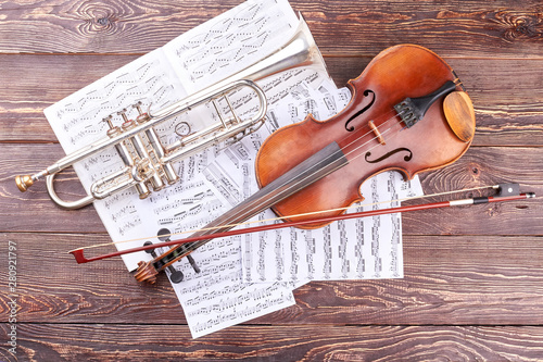 Photography Trumpet and violin on wooden background