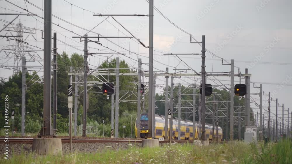 Dutch Double Decker train passes in high speed near Hilversum and Utrecht on a sunny day, Utrecht, The Netherlands, July 12th 2019