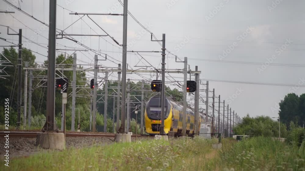 Dutch Double Decker train passes in high speed near Hilversum and Utrecht on a sunny day
