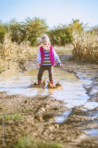 enjoying summer sunny day and water puddle after rain photo