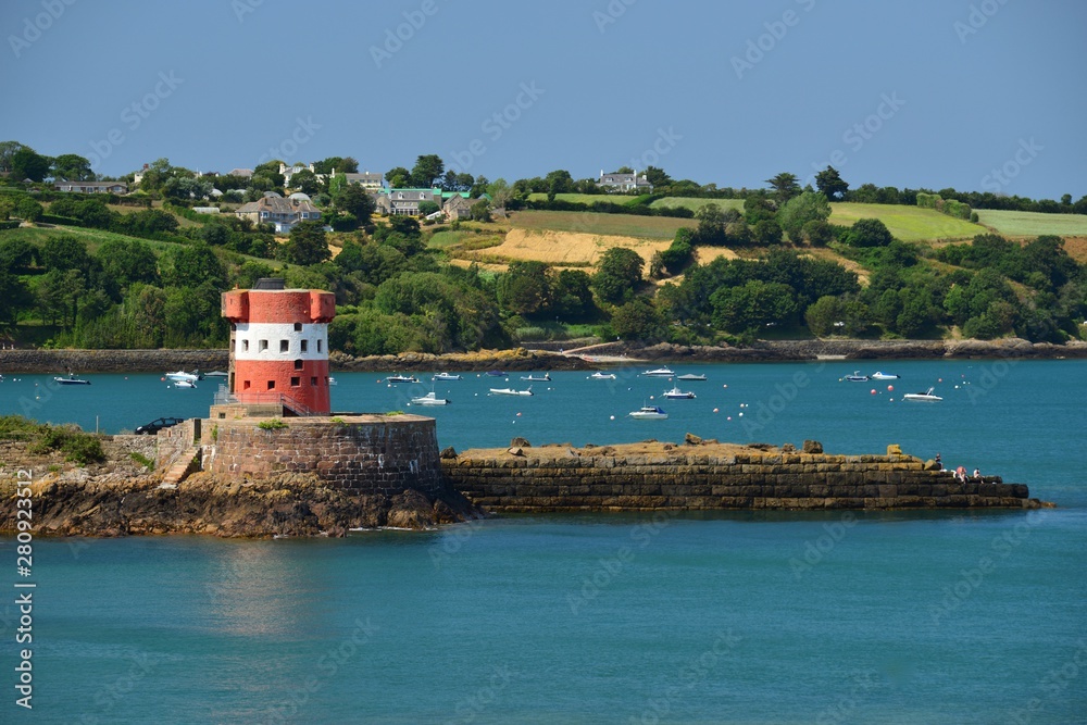 St Catherine's Bay, Jersey, U.K. 19th century military toweer and harbour in the Summer.