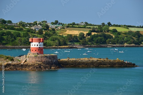St Catherine's Bay, Jersey, U.K. 19th century military toweer and harbour in the Summer.