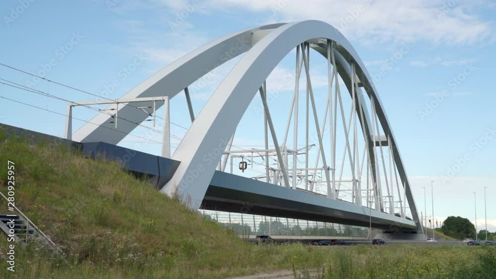 Double Decker train passing on the train bridge from Flevoland to Amsterdam crossing Commuters in cars driving on highway A1, Muiden, The Netherlands, July 9th 2019 Double Decker train passing on the train bridge from Flevoland to Amsterdam crossing Commuters in cars driving on highway A1, Muiden, The Netherlands, July 9th 2019