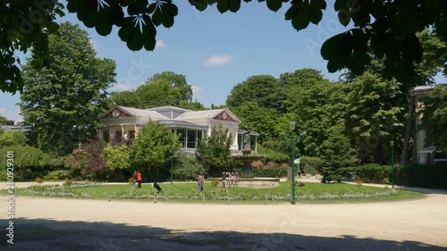 Locals and tourists walking in Jardin (garden) des Champs-Elysees and enjoying the sun in the center of Paris, France, July 3th 2019 photo