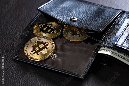 Golden bitcoins in leather wallet, shallow focus