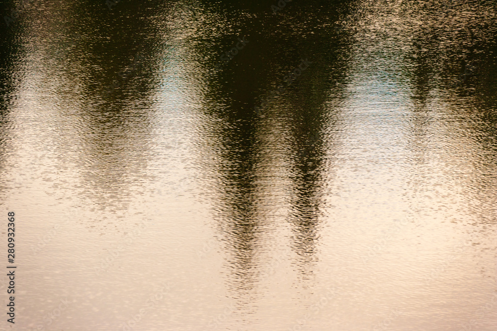 Reflection of evergreen trees in rippling water, Stowe, Vermont, USA Reflection of evergreen trees in rippling water, Stowe, Vermont, USA
