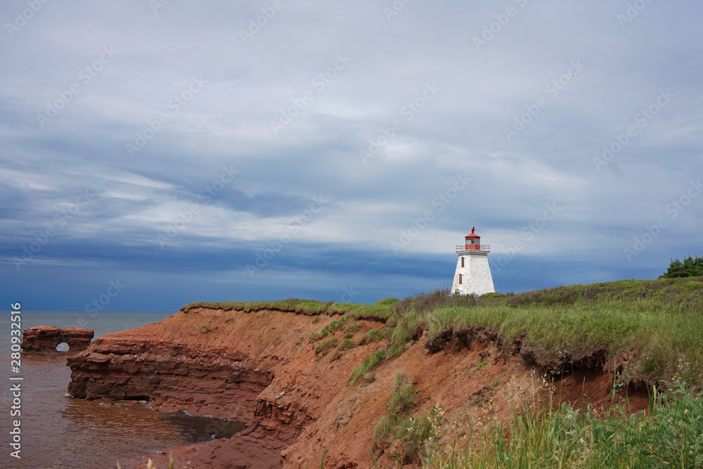 Cape Egmont coastline on Prince Edward Island Canada with red cliffs and a lighthouse