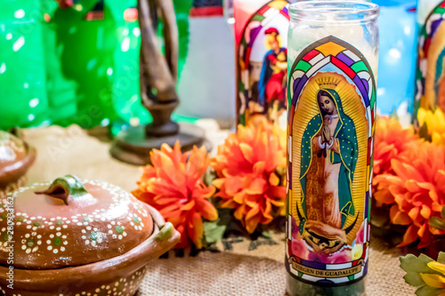 Photography Closeup of an Altar with Saint Candles and Marigolds Displaying Traditional Mexi