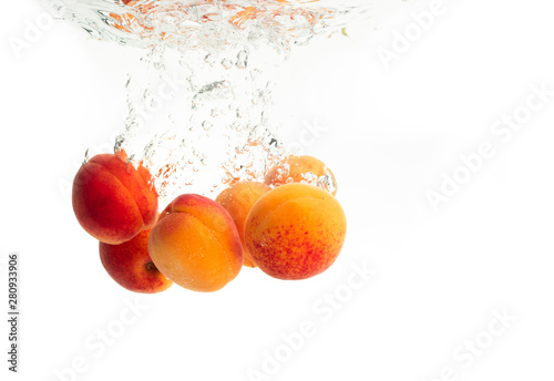 Fresh Apricots with water splash isolated over white background