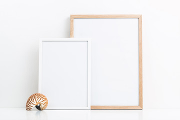 minimal marine / ocean or summer themed mockup with two photo frames and a decorative nautilus shell on a white table, clipping path included, sizes: 30 x 40 cm, 21 x 30 cm