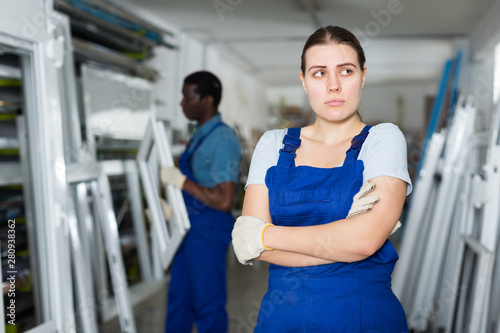 Portrait of young woman master who is dissatisfied of working with modern windows © JackF