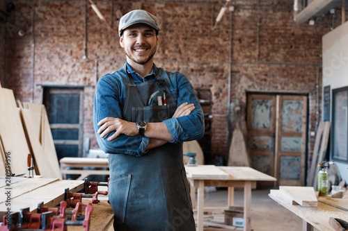 Tableau sur toile Successful handsome businessman with stylish cap work in carpentry