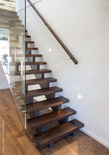 Canvas Modern wooden staircase with large thick glass balustrade