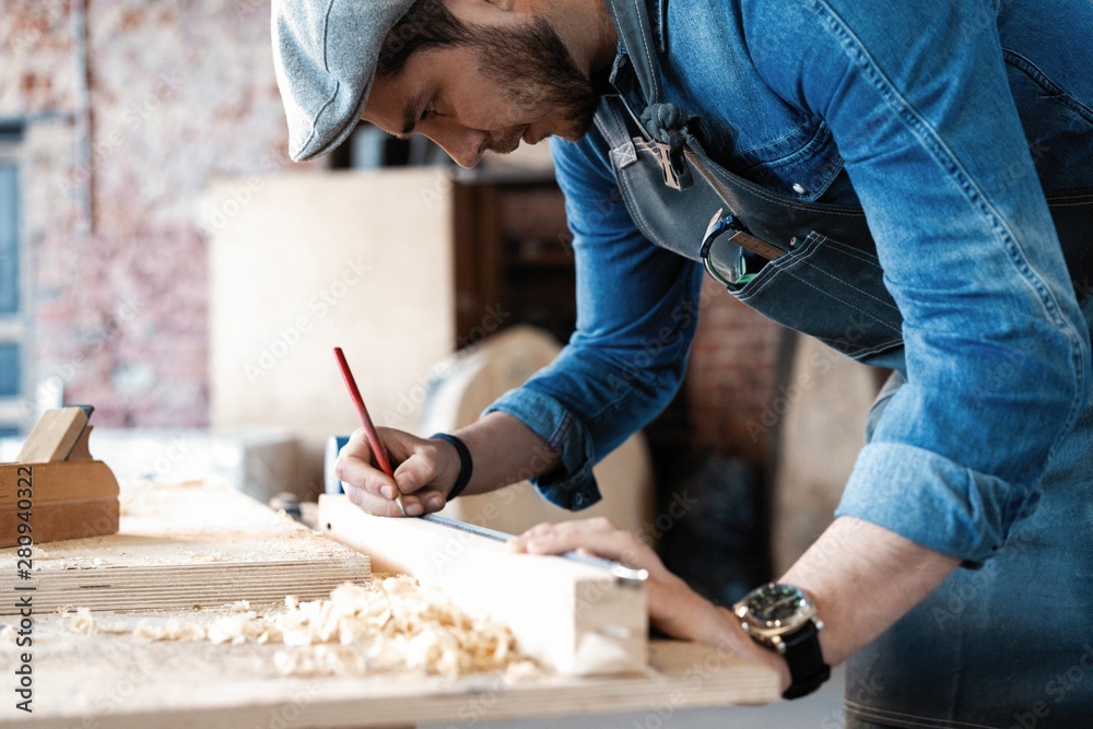 Successful handsome businessman with stylish cap work in carpentry Successful handsome businessman with stylish cap work in carpentry