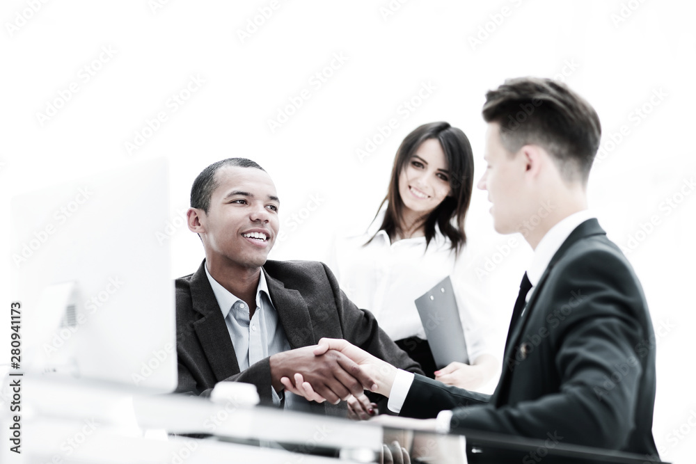 handshake of business partners sitting at a table Desk handshake of business partners sitting at a table Desk
