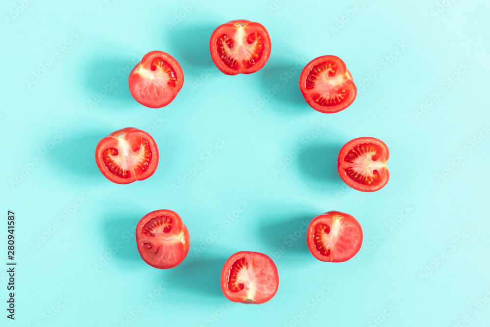 Tomato pattern. Frame made of fresh half tomatoes on light blue background. Flat lay, top view, copy space Tomato pattern. Frame made of fresh half tomatoes on light blue background. Flat lay, top view, copy space