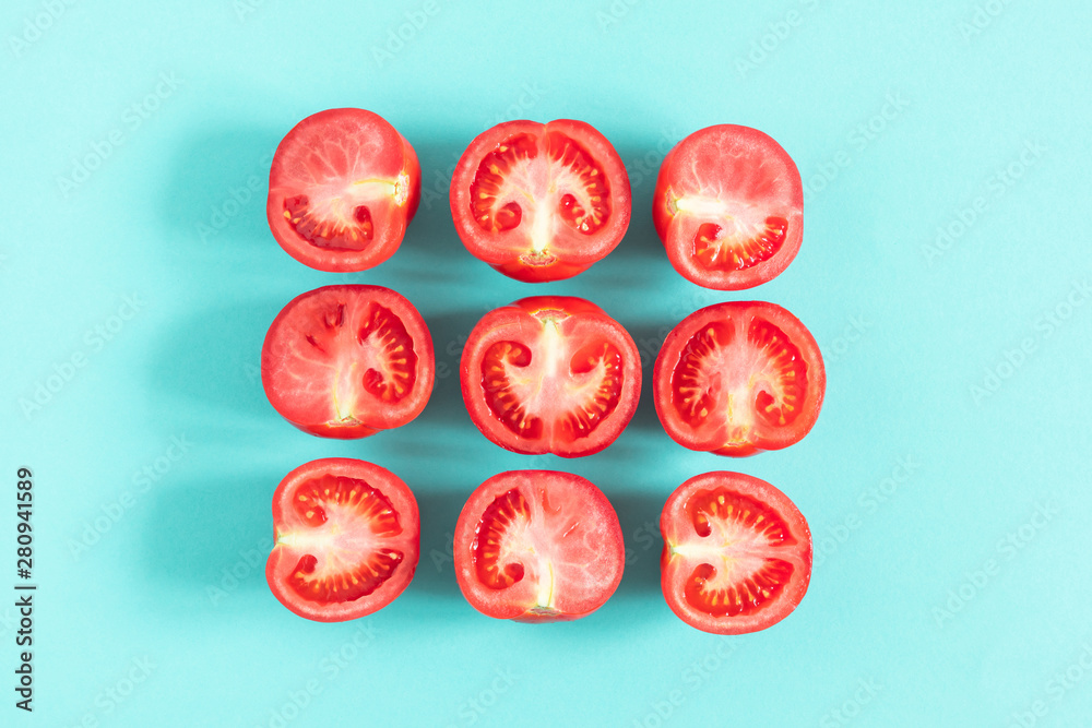 Tomato pattern. Frame made of fresh half tomatoes on light blue background. Flat lay, top view, copy space Tomato pattern. Frame made of fresh half tomatoes on light blue background. Flat lay, top view, copy space