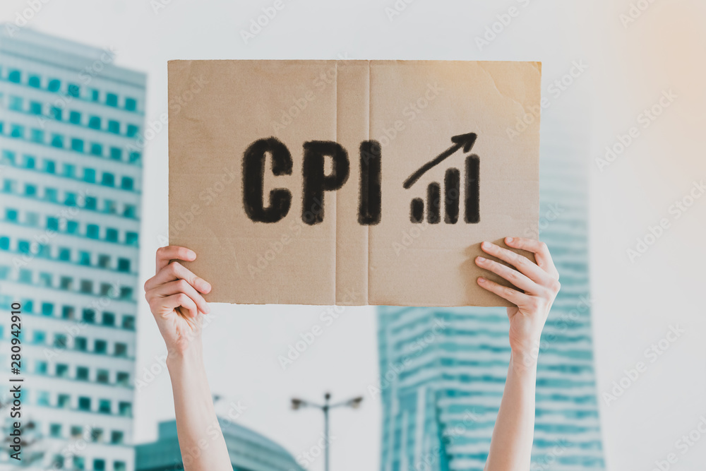 The abbreviation " CPI " and arrow going up icon drawn on a carton banner  in men's hand. Human holds a cardboard with an inscription: CPI. Gain.  Growth. Rise. Increase Stock Photo