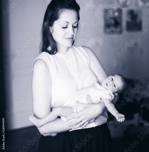 black-and-white photos of a young mother holding a newborn baby